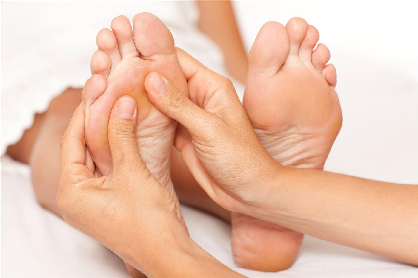 A reflexology treatment, both feet worked together