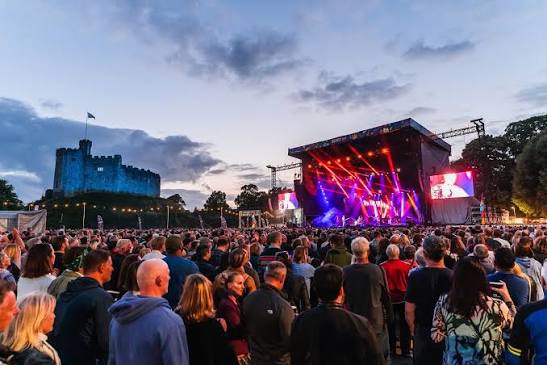 A concert crowd at Cardiff Castle at dusk
