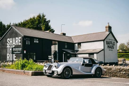 BaffleHaus pub with a classic sports car parked outside