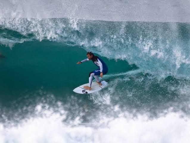 A surfer riding a wave at Porthcawl